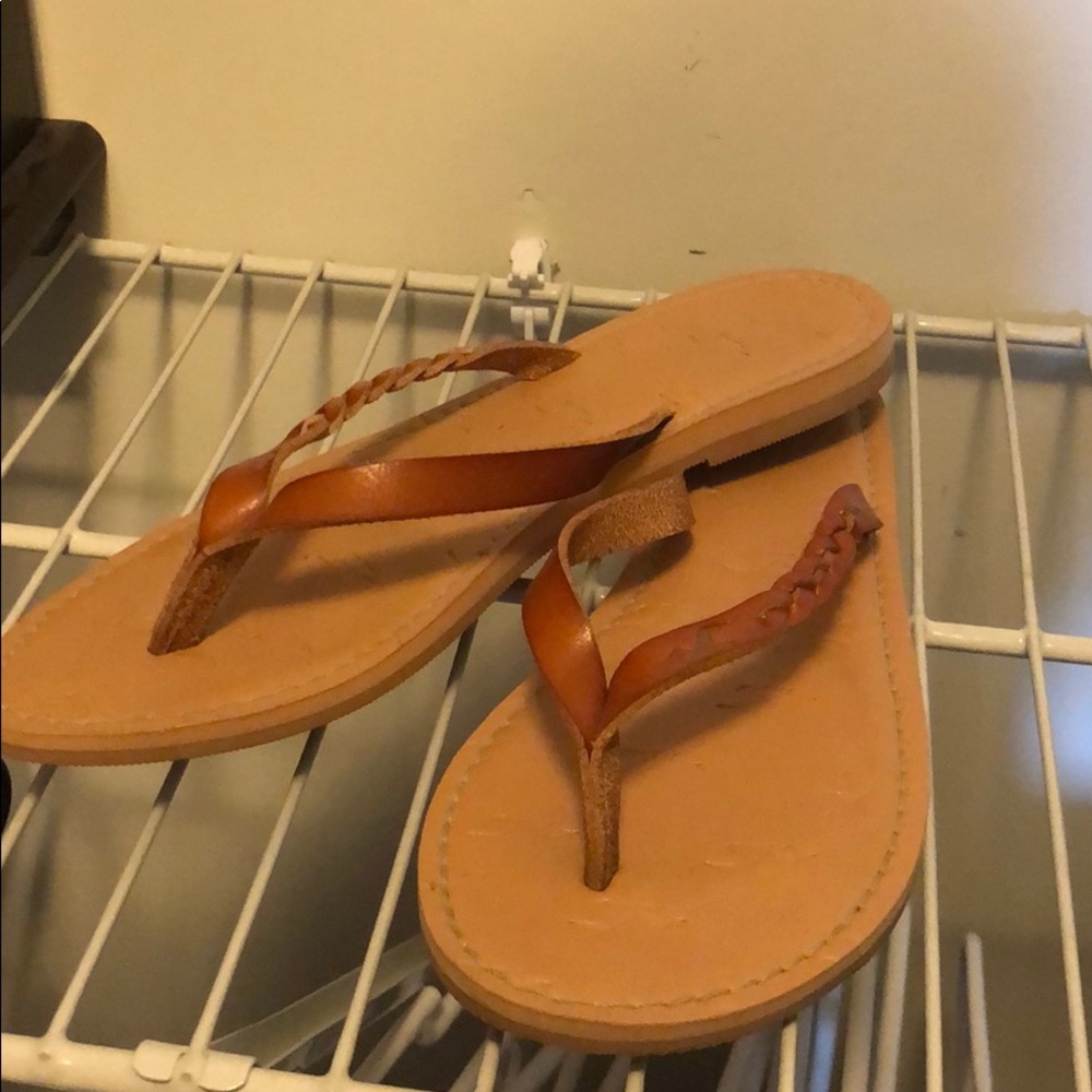 Tan flip flops